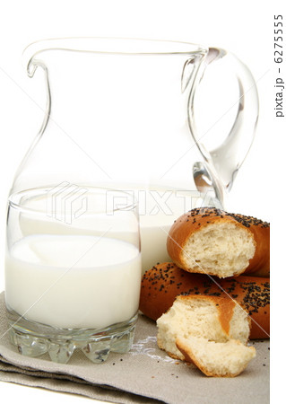 Bagel with poppy seeds a pitcher of milk. Bagel with poppy seeds a pitcher of milk. 6275555
