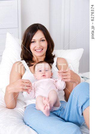 Mother with baby sitting at home in casuals Mother with baby sitting at home in casuals 6276374