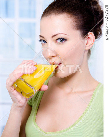caucasian woman with a glass of orange juice caucasian woman with a glass of orange juice 6277579