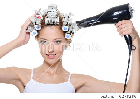 woman with hair-curles and hairdryer doing hairstyle 6278286
