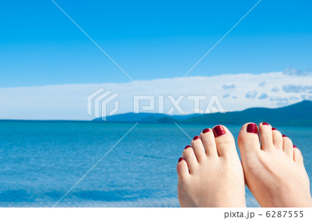 womans feet against sea and blue sky 6287555