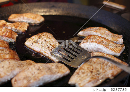 pieces of salmon fry in a large frying pan 6287786