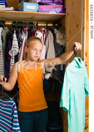 Family - child in front of her closet or wardrobe 6289299