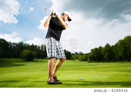 Young golf player on course doing golf swing Young golf player on course doing golf swing 6289316