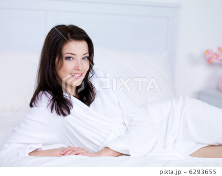 Woman with smile on a bed Woman with smile on a bed 6293655