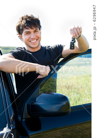 happy man showing keys near the car 6296947