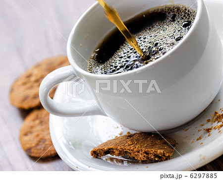 Coffee and oatmeal cookies on wooden table Coffee and oatmeal cookies on wooden table 6297885