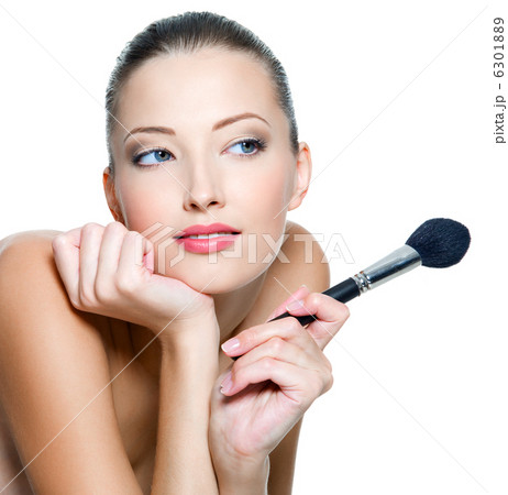 woman  holds make-up brushe for applying  rouge 6301889