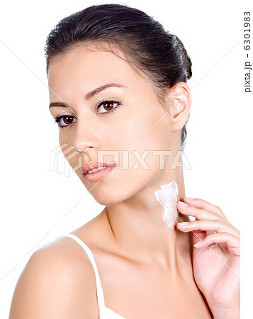 Woman applying cream on her neck Woman applying cream on her neck 6301983