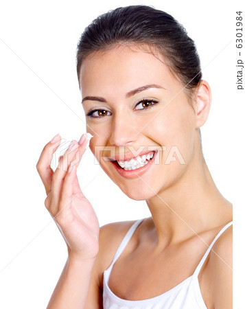Smiling woman applying moisturizer cream Smiling woman applying moisturizer cream 6301984