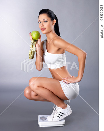 Health woman stands on scales Health woman stands on scales 6309083