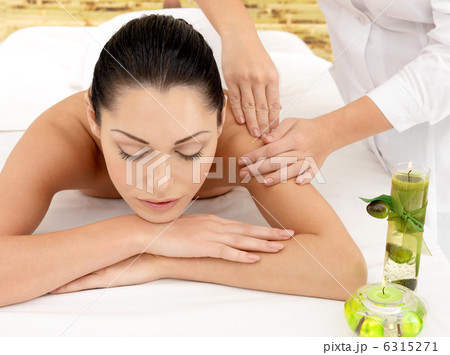 Woman having massage of shoulder in spa salon Woman having massage of shoulder in spa salon 6315271