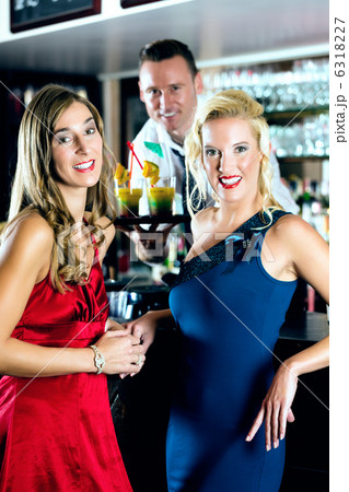 Young women and bartender in club or Bar Young women and bartender in club or Bar 6318227