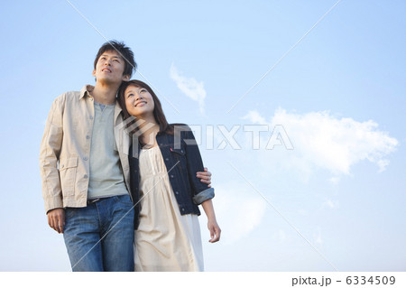 寄り添って空を見上げているカップル 6334509