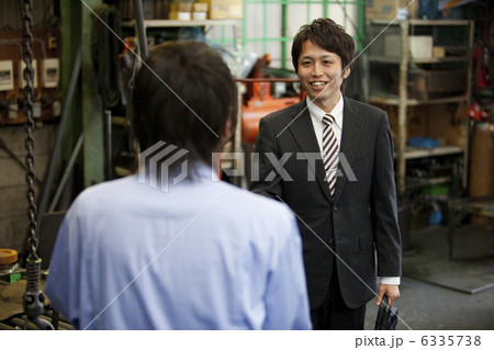 スーツの男性と作業着姿の男性の後姿 6335738