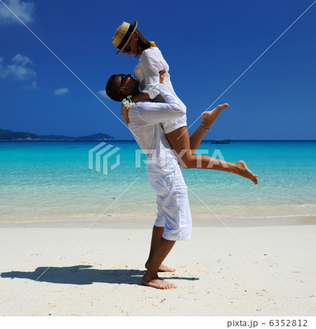 Couple in white on a beach 6352812
