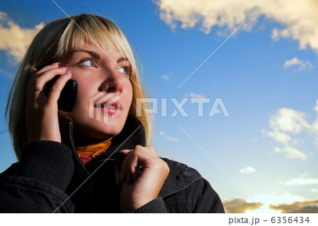 Blonde girl talking on the cell phone  6356434
