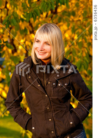 Cute smiling girl on autumn background Cute smiling girl on autumn background 6356436