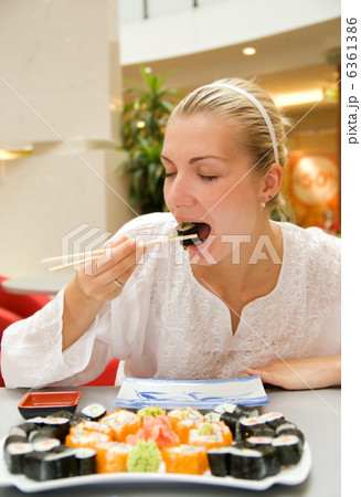 Girl eats sushi in a restaurant Girl eats sushi in a restaurant 6361386