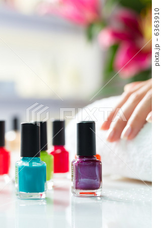 Woman in nail salon receiving manicure 6363910