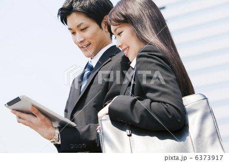 タブレットPCを持つスーツ姿の若い男性と女性 タブレットPCを持つスーツ姿の若い男性と女性 6373917