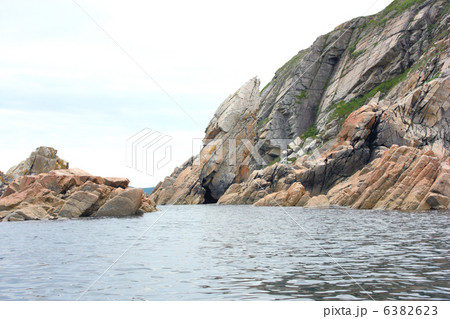 Rocks in the blue sea, illuminated by the sun. Background. Rocks in the blue sea, illuminated by the sun. Background. 6382623