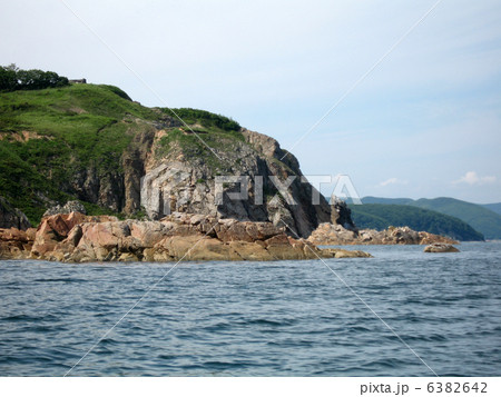 Rocks in the blue sea, illuminated by the sun. Background. Rocks in the blue sea, illuminated by the sun. Background. 6382642