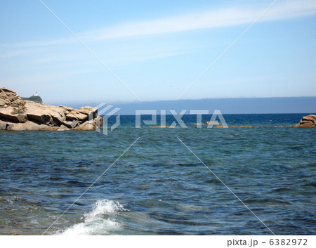 Rocks in the blue sea, illuminated by the sun. Background. 6382972