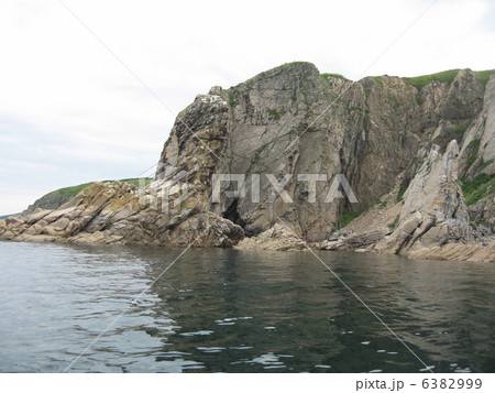 Rocks in the blue sea, illuminated by the sun. Background. 6382999