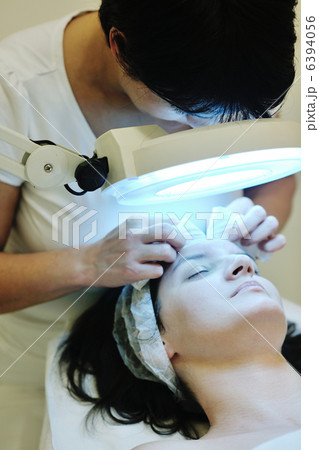 woman with facial mask in cosmetic studio 6394056