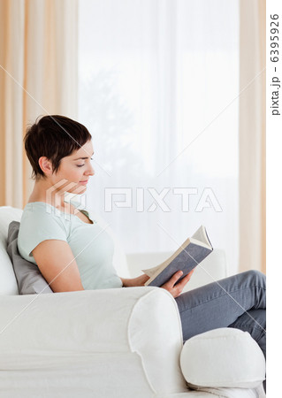 Portrait of a short-haired woman reading a book Portrait of a short-haired woman reading a book 6395926