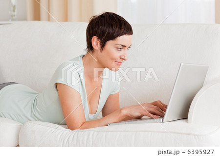 Happy short-haired woman using a laptop Happy short-haired woman using a laptop 6395927