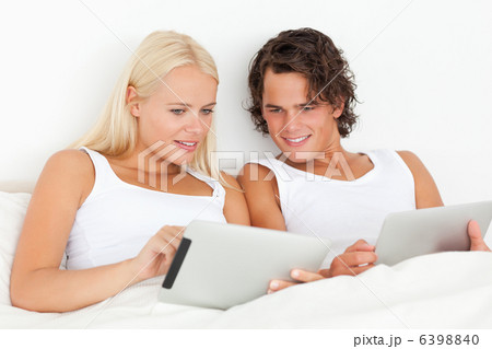 Gorgeous couple using tablet computers Gorgeous couple using tablet computers 6398840