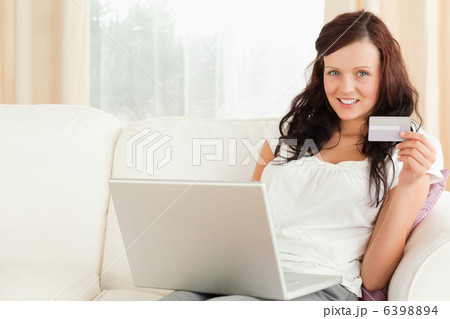 Gorgeous red-haired doing online shopping 6398894