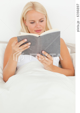 Portrait of a blonde woman reading a book 6398897