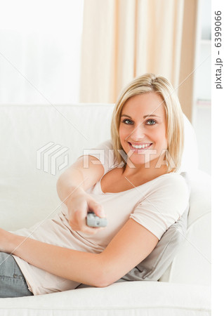 Portrait of a woman pointing a remote at the camera Portrait of a woman pointing a remote at the camera 6399066
