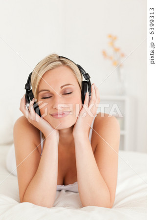 Portrait of a delighted woman wearing headphones Portrait of a delighted woman wearing headphones 6399313