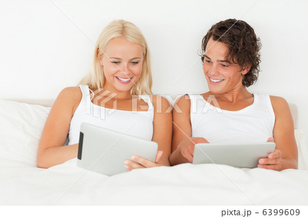 Couple using tablet computers 6399609