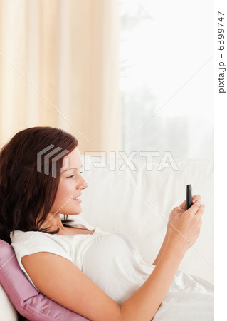 Lovely woman texting with mobile phone 6399747