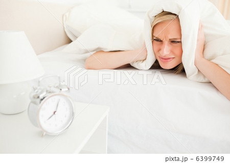 Displeased young woman waking up 6399749