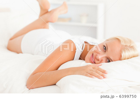 Lovely woman lying on her bed 6399750