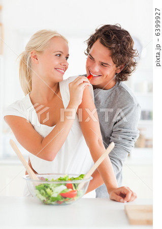 Portrait of a woman giving pepper to her fiance Portrait of a woman giving pepper to her fiance 6399927