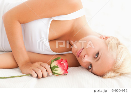 Close up of a quiet woman with a flower 6400442