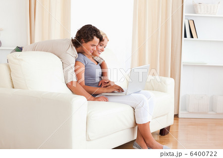 Smiling young couple using a notebook Smiling young couple using a notebook 6400722