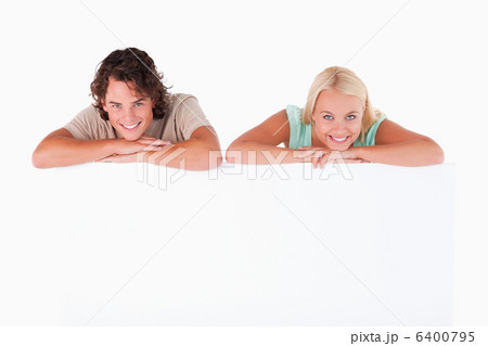 Smiling couple leaning on a whiteboard Smiling couple leaning on a whiteboard 6400795