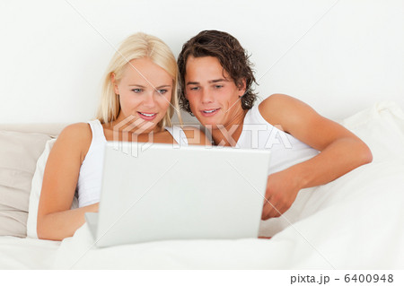 Young couple watching a movie with a laptop 6400948