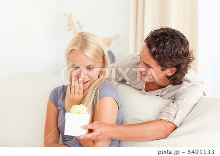 Man offering a present to his girlfriend Man offering a present to his girlfriend 6401133