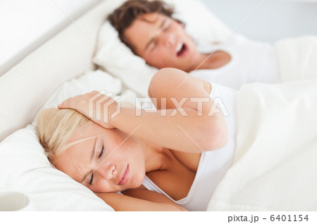 Woman awaken by her boyfriends snoring Woman awaken by her boyfriends snoring 6401154