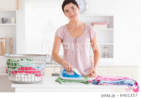 Cute Woman ironing clothes 6401357