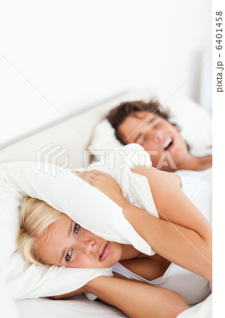 Portrait of a woman awaken by her husbands snoring 6401458